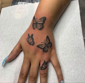 Black butterfly tattoo on hand designs