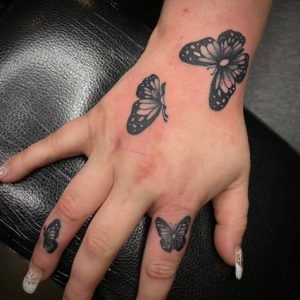 Black butterfly tattoo on hand ideas