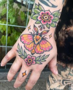 Rosy-Maple-Moth-tattoo-with-flower