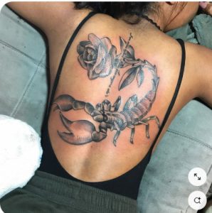 Scorpion tattoo with flowers