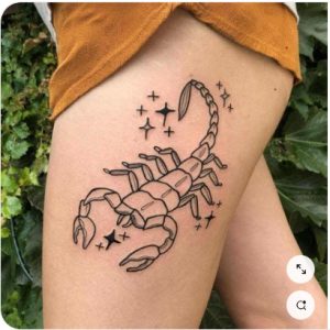 scorpion tattoo on thigh